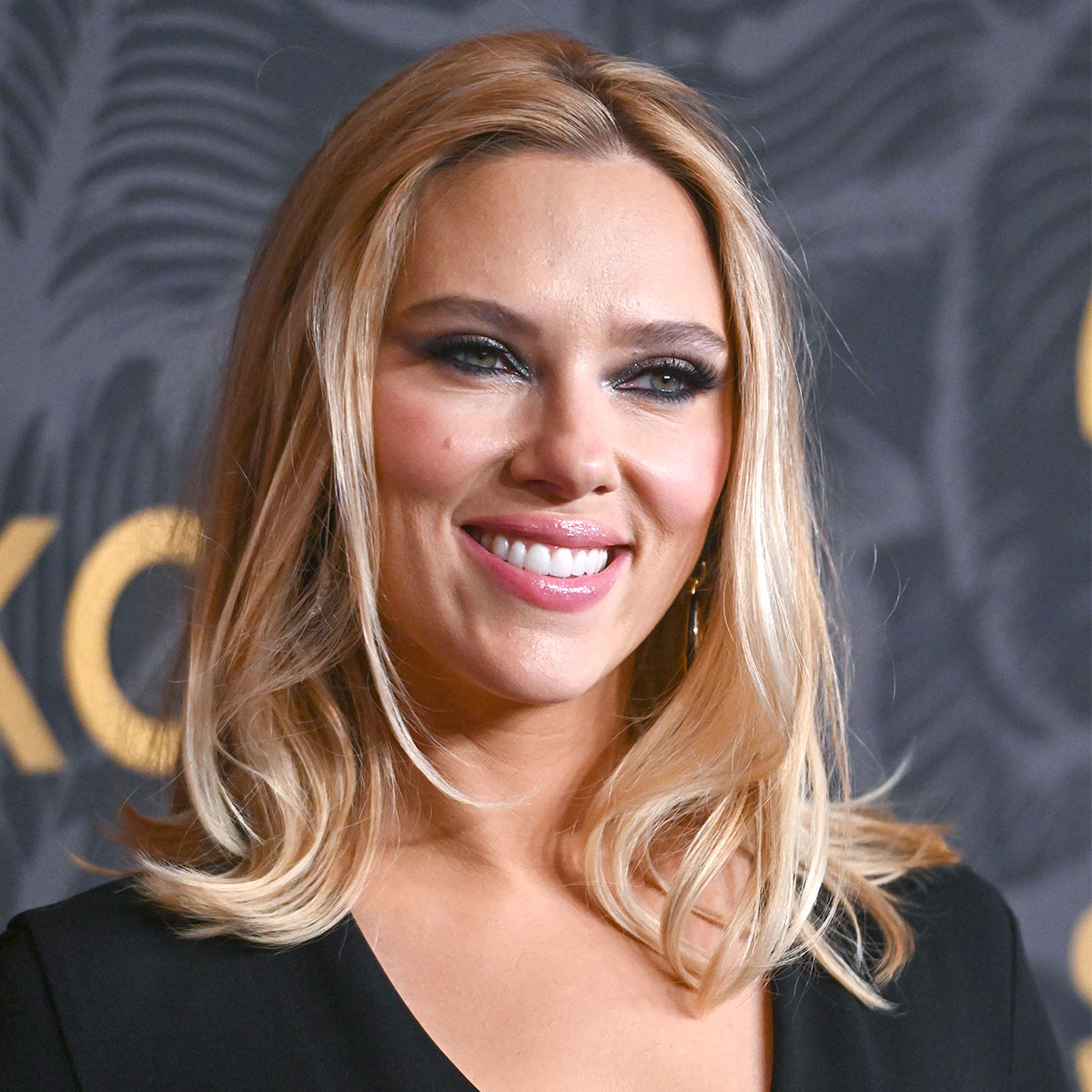 Scarlett Johansson Stuns In A Black Wrap Costume And Patterned Tights For The 2023 Golden Coronary heart Awards