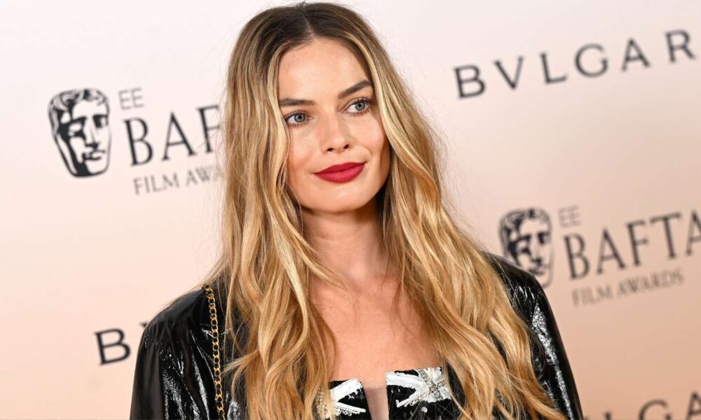 Margot Robbie Made a Uncommon Purple Carpet Look With Tom Ackerley