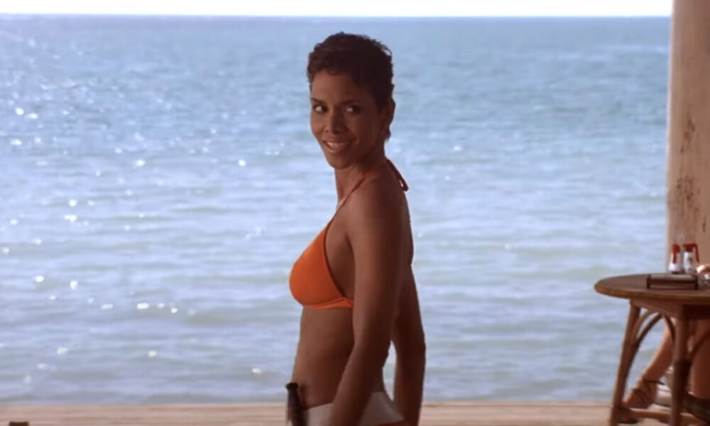 Halle Berry Leaping On A Trampoline In A Cute Swimsuit Whereas Getting Sprayed With Water Is Giving The Power I Want To Begin The Summer season