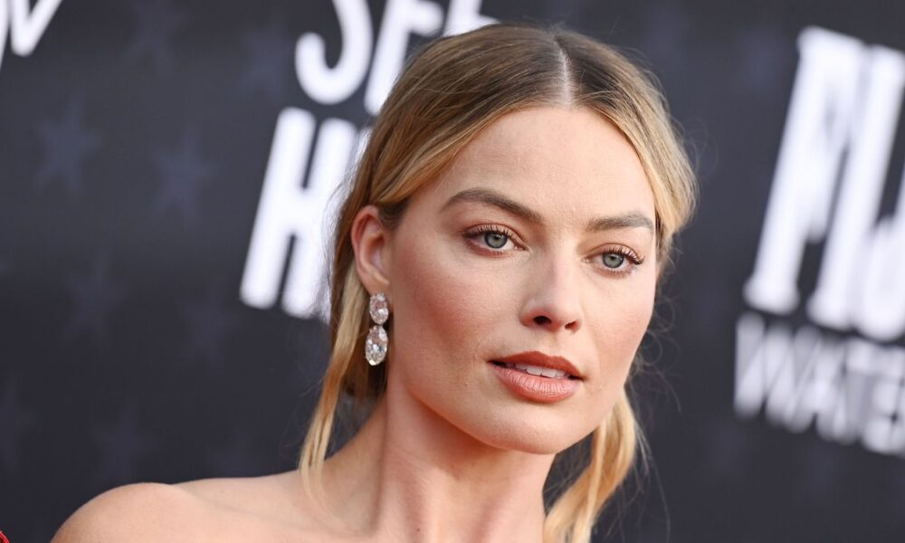Margot Robbie’s Aspect Boob-Baring Bare Costume Comes With Crystal Thong